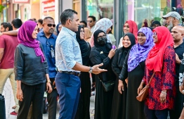 Vice president Faisal Naseem speaks with people at a polling station after casting his vote in the second round of the presidential election -- Photo: Fayaz Moosa