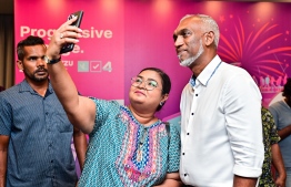 A supporter taking a selfie with Dr. Muizzu during the press conference.
