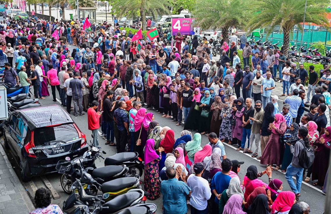 ކުރީގެ ރައީސް ޔާމީން ޖަލުން ގޭ ބަންދަށް ބަދަލުކުރުމުން ގެކޮޅަށް ވަޑައިގަންނަވާ ވަގުތެއްގެ އިންތިޒާރުގައި ސަޕޯޓަރުންތައް އެއްވެފައި: ޔާމީނަށް މަރުހަބާ ކިޔަން އެތައް ސަތޭކަ ބަޔަކު އެ މަނިކުފާނުގެ ގެކޮޅު ކައިރި އަށް ޖަމާވި. ޔާމީނަށް އިސްވެ މަރުހަބާ ދެންނެވީ އިންތިހާބީ ރައީސް ޑރ. މުހައްމަދު މުއިއްޒު.---ފޮޓޯ: ނިޝާން އަލީ| މިހާރު