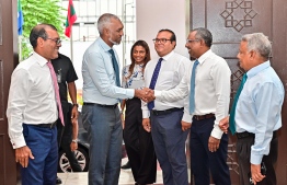 President-elect Dr. Muizzu shaking hands with Minority leader of the parliament and MP for Central Henveiru Constituency Azim, while speaker of parliament Nasheed looks on -- Photo: Fayaz Moosa
