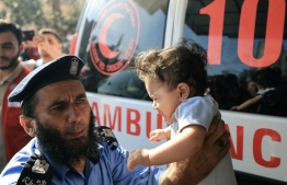 A child injured in the attacks on Gaza being taken for treatment. Protests against Israel have sprung up in multiple countries following the attack on Al-Ahli hospital -- Photo: AFP