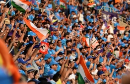 Cricket fans cheer during the 2023 ICC Men's Cricket World Cup one-day international (ODI) match between India and Pakistan at the Narendra Modi Stadium in Ahmedabad on October 14, 2023. -- Photo: Sam Panthaky / AFP