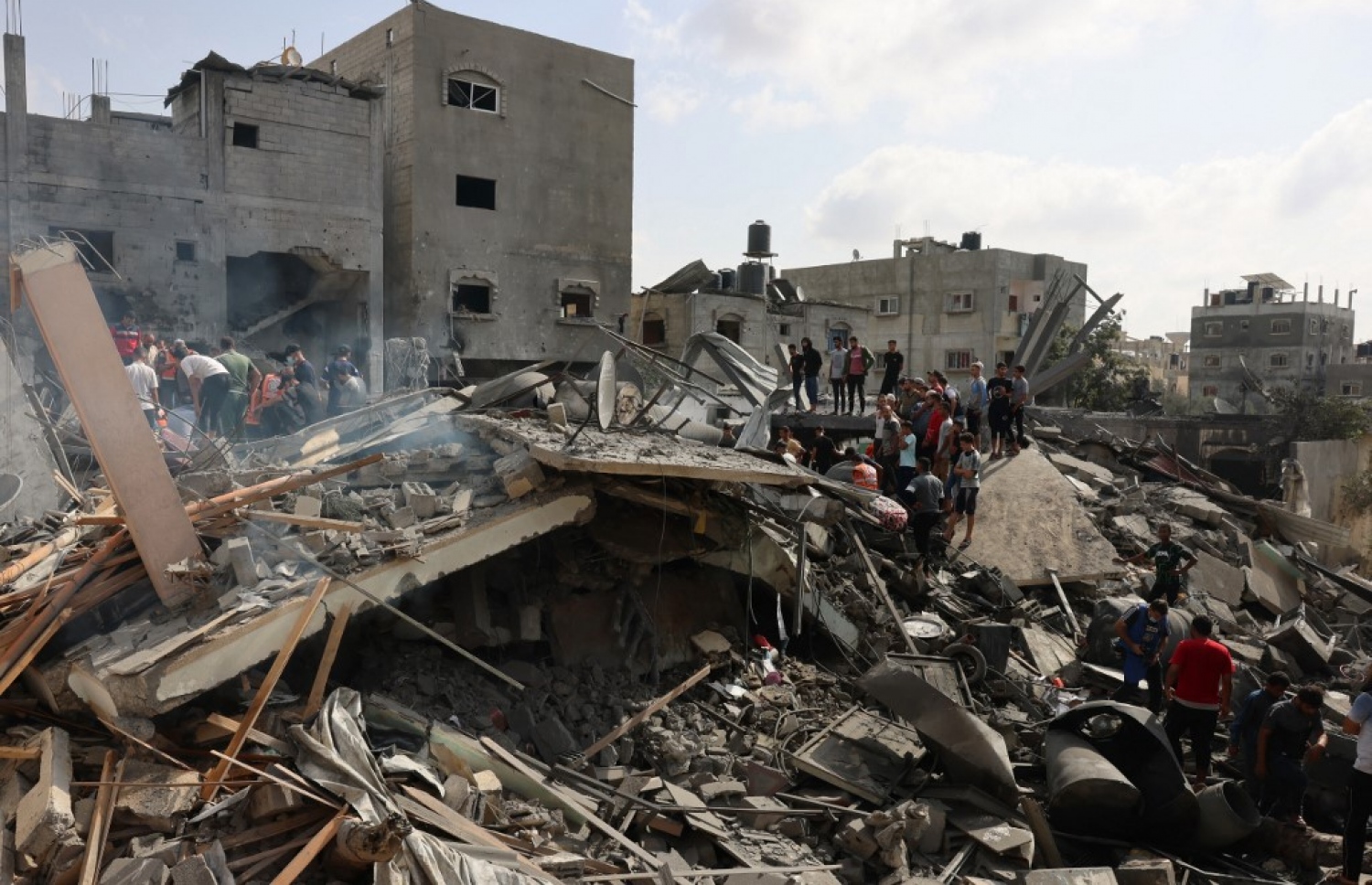 އިޒްރޭލުން ގާޒާއަށް ދިން ރޮކެޓު ހަމަލާއެއްގައި ވެއްޓިފައި އިމާރާތްތަކުން މީހުން ސަލާމަތް ކުރުމުގެ މަސައްކަތް ކުރަނީ. --ފޮޓޯ: އޭއެފްޕީ