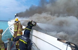 MNDF Fire and Rescue team working to extinguish the fire on a yacht near the Ritz-Carlton Resort -- Photo: MNDF