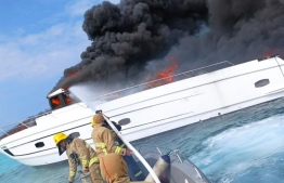 MNDF Fire and Rescue team working to extinguish the fire on a yacht near the Ritz-Carlton Resort -- Photo: MNDF