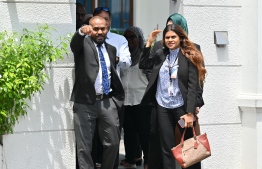 Parliament's Counsel General Fathimath Filza along with a few members of the parliament secretariat with a court staff in front of Supreme Court's entrance-- Photo: Mihaaru