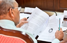 A Budget Committee member looking over the supplementary budget on November 16, 2023 -- Photo: Nishan Ali / Mihaaru