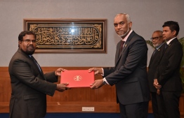 Dr Shaugee receiving his letter of appointment from President Dr Muizzu.-- Photo: President's Office