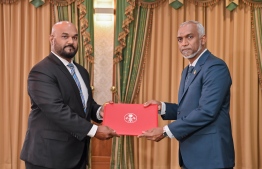 Yoosuf Maniu receives his letter of appointment.-- Photo: President's Office