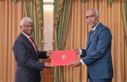 Fahmy being handed his letter of appointment for the post of State Minister at the Ministry of Foreign Affairs.-- Photo: President's Office