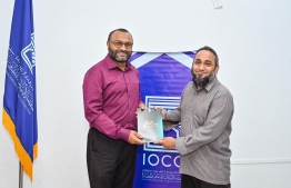 Islamic Minister Dr. Mohamed Shaheem Ali Saeed previously presenting his new published book to now Deputy Minister Ali Ahusan.-- Photo: Mihaaru