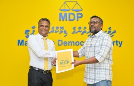 Azim hands in Mayoral primary candidacy form to MDP Chairperson Fayyaz.-- Photo: Nishan Ali / Mihaaru