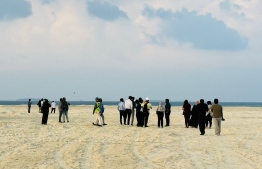 Government officials on the reclaimed land from Fushidhiggaru lagoon yesterday