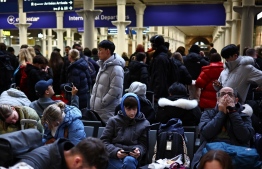 Passengers wait for news of Eurostar departures at St Pancras station in London on December 30, 2023, as services are disrupted due to flooding. Eurostar trains were were cancelled on Saturday due to flooded tunnels, causing misery for people travelling for New Year celebrations in the second major disruption in 10 days. -- Photo: Henry Nicholls / AFP