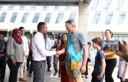 Tourism Minister Ibrahim Faisal welcomes the 1.8 millionth tourist to the Maldives this year -- Photo: Ministry of Tourism