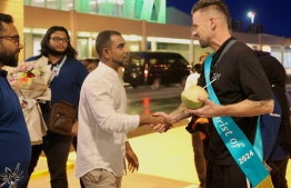 Tourism Minister Ibrahim Faisal and senior officials of the ministry welcome the first tourist to the Maldives this year at Velana International Airport. -- Photo: Immigration
