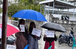 Dhambidhoo parents continue their protest despite the rain.-- Photo: Council