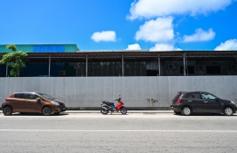 A motorcycle parked in between two cars in an area designated for car parking on Izzuddin Magu: It has become a common practice in Malé for car drivers to park motorcycles in such zones to avoid losing the space. As a result, many people are suffering due to a lack of parking space. -- Photo: Fayaaz Moosa