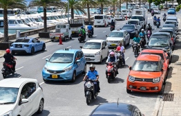 Cars and pickups parked on both sides of Boduthakurufaanu Magu: There is a steep increase in illegal parking since issuing parking violation stickers have been halted. -- Photo: Fayaaz Moosa