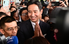 Former Thai prime ministerial candidate and ex-Move Forward Party leader Pita Limjaroenrat (C) gestures as he is surrounded by media outside the Constitutional Court in Bangkok on January 24, 2024, after the court decided to reinstate him as a lawmaker. Thailand's Constitutional Court on January 24 cleared reformist political leader Pita Limjaroenrat in a case that could have seen him banned from parliament, and reinstated him as an MP. -- Photo: Manan Vatsyayana / AFP