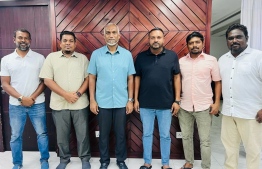 President Dr Muizzu and leaders of PNC photographed with new members joining the party.