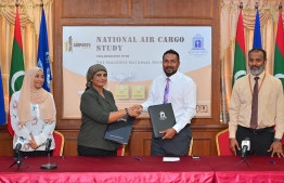 Vice Chancellor of MNU Dr. Aishath Shehenaz Ahmed (L2) shaking hands with Managing Director of RACL Ahmed Mubeen after signing an MoU between RACL and MNU to conduct a national study on air cargo on February 1, 2024 -- Photo: Nishan Ali / Mihaaru