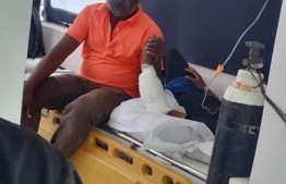 The individual who sustained injuries to his arm in the shark attack in the sea ambulance, being transferred to hospital.-- Photo: Ihavandhoo Fishermen's FB Page