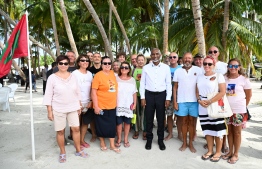 President Dr Muizzu poses for a picture with tourists currently visiting Buruni.-- Photo: President's Office