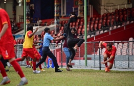 Police try to stop violence at Galolhu Stadium during a match