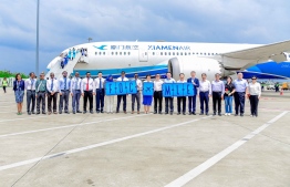 The crew of Xiamen Airline holding cards showing the name cards for Fujian, the city the flight came from, and the one to Male', at Velana International Airport on Wednesday, February 14, 2024 -- Photo: Ministry of Tourism