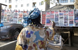 A Senegalese woman reads the headlines of the newspapers on sale in a street in Dakar on February 16, 2024. Senegal's Constitutional Council on February 16, 2024 overturned the postponement of this month's presidential election, a historic decision that opens up a realm of uncertainty for the traditionally stable West African nation. 
President Macky Sall's decision earlier this month to postpone the February 25 poll plunged Senegal into its worst crisis in decades, sparking widespread outcry and prompting deadly protests. -- Photo: Seyllou / AFP