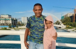 Nasrulla Ahmed with his daughter. He dedicated the medal won in his 94th marathon to his daughter.