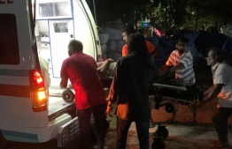 A man injured in the speedboat collision being put in an ambulance