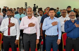 President Dr Mohamed Muizzu, Vice President Hussain Mohamed Latheef and Special Advisor to the President, Abdul Raheem Abdulla saluting through the national anthem at the ceremony held in Ha. Vashafaru -- Photo: President's office