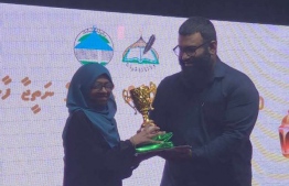 Alva Hussain receiving her award for her rank in the Quran competition