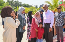 The residential community of M.Mulah receiving President Dr Mohamed Muizzu upon his arrival at the island -- Photo: Mihaaru News
