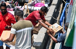 Goods being loaded onto a vessel in the Male' Local Market area: World Bank has reduced its forecast for Maldives economic growth for the year by 0.5 percent -- Photo: Fayaz Moosa