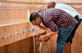 Person performing ablution for prayers at Islamic Centre -- Photo:  Nishan Ali