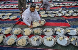 Volunteers prepare the plates of Iftar food for Muslim devotees on the first day of the Islamic holy month of Ramadan at Memon Masjid in Karachi on March 12, 2024. -- Photo: Rizwan Tabassum / AFP
