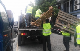 Wooden pallets being removed from Male' rods by Male' City Council -- Photo: Male' City Council
