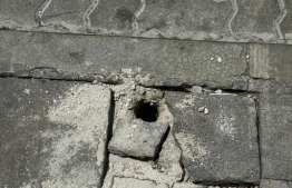 Holes punctured into the pavement of Male' City roads to attach poles -- Photo: Male' City Council