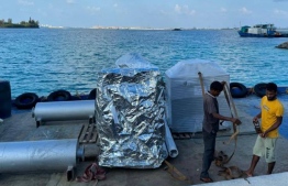 The new generator being loaded into the supply boat to be transferred to HDh. Vaikaradhoo.