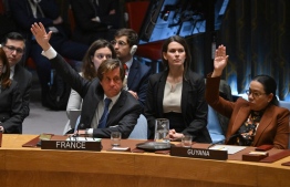 French Ambassador to the UN Nicolas de Riviere (L) votes yes on a resolution calling for an immediate ceasefire in Gaza during a United Nations Security Council meeting on the situation in the Middle East, including the Palestinian question, at the UN headquarters in New York on March 25, 2024. After more than five months of war, the UN Security Council for the first time passed a resolution calling for an immediate ceasefire in Gaza. The United States, Israel's ally which vetoed previous drafts, abstained. -- Photo: Angela Weiss / AFP