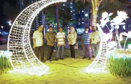STELCO MD Fahmy observes the putting up of festive lights across Male' City, pictured near a crescent shaped light placed near Hiyaa Flats in Hulhumale'.