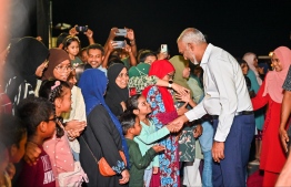 President Dr Muizzu shakes hands with some children attending Monday night's event.-- Photo: Fayaz Moosa / Mihaaru