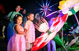 Joyous children amongst the lights at the Republic Square.-- Photo: Fayaz Moosa / Mihaaru