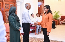 President Dr Muizzu and First Lady Sajida greet a young girl.-- Photo: President's Office