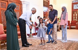 President Dr Muizzu and First Lady Sajida greet a family.-- Photo: President's Office