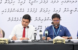 Transport Minister Ameen and MTCC CEO Ziyad signs the agreement today.-- Photo: Nishan Ali