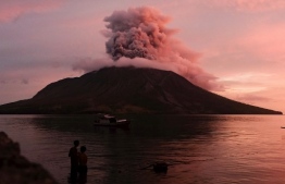 Mount Ruang volcano erupts in Sitaro, North Sulawesi, on April 19, 2024: Volcanic activity has calmed at the crater of Mount Ruang and the country's volcanology agency lowered the alert level to the second-highest of a four-tiered system. -- Photo by Ronny Adolof Buol / AFP